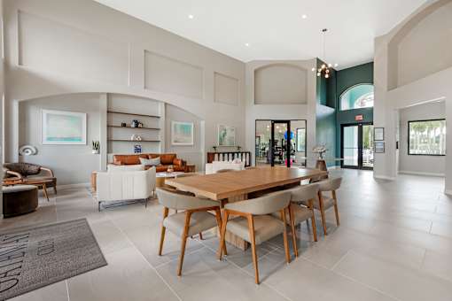 A modern dining room with a wooden table and chairs.