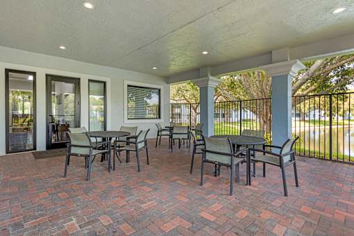 A patio with a table and chairs.
