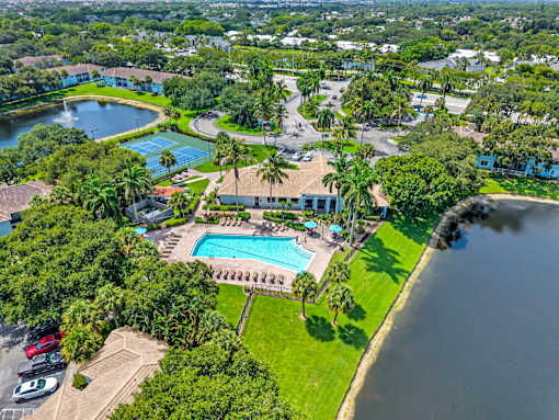 A bird's eye view of a resort with a swimming pool and a lake.