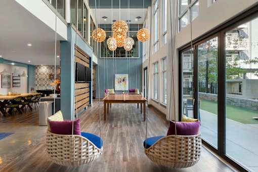 A modern interior with a pool table and chairs at Glenwood at Grant Park, Georgia 30316