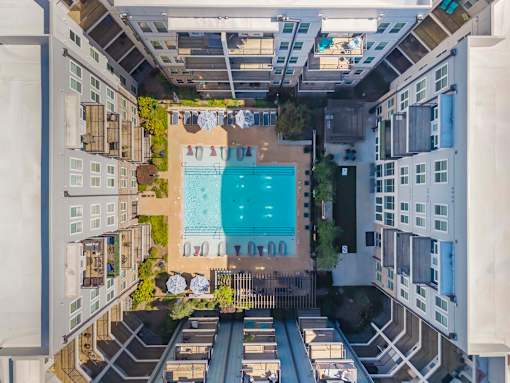 A swimming pool is surrounded by apartment buildings at Glenwood at Grant Park, Atlanta, GA