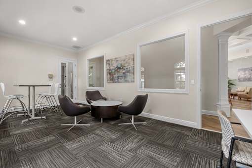 A room with a table and chairs in it.