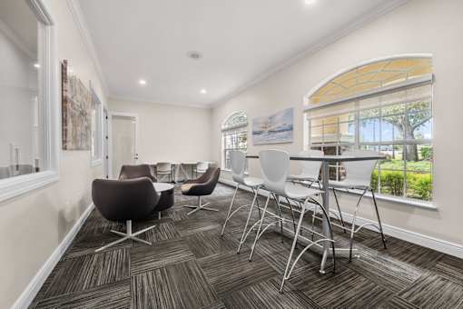 A conference room with a table and chairs.