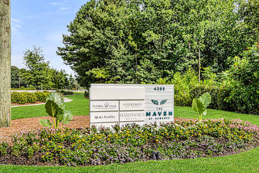 A sign in front of a tree reads 4255 Global Cave Adoremel.