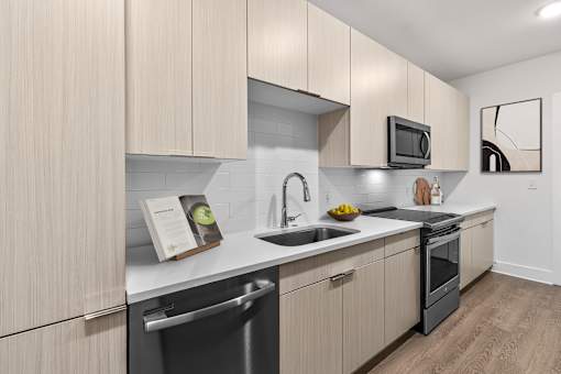 A modern kitchen with wooden cabinets and stainless steel appliances.