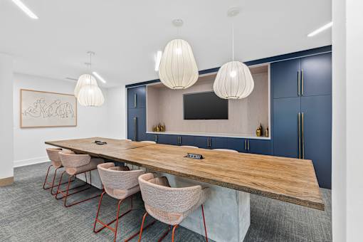 A conference room with a long table and chairs.