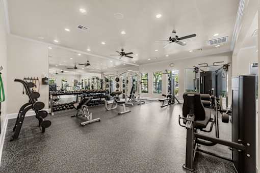 A spacious home gym with a variety of equipment.
