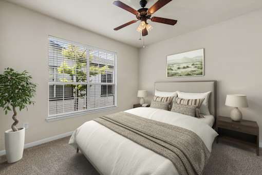A bedroom with a bed, a ceiling fan, and a potted plant.
