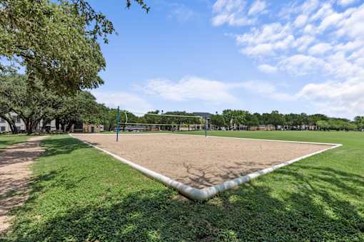 A baseball field with a white base and green grass.