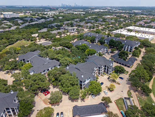 A bird's eye view of a residential area with houses and cars.