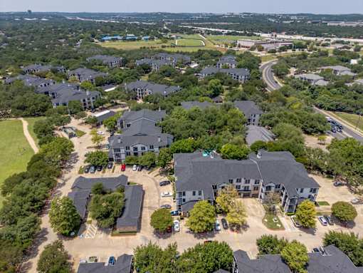 A bird's eye view of a residential area with houses and trees.