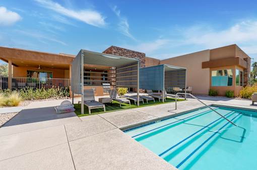 A modern house with a pool in the backyard.