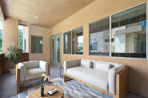 A living room with a sofa, armchair, and coffee table.