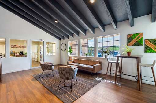 A living room with a couch, chairs, and a table.