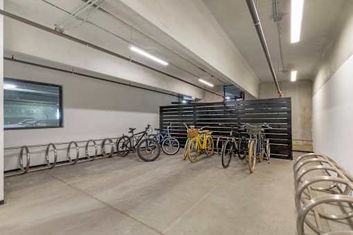 A bike parking area with bicycles parked in metal racks.