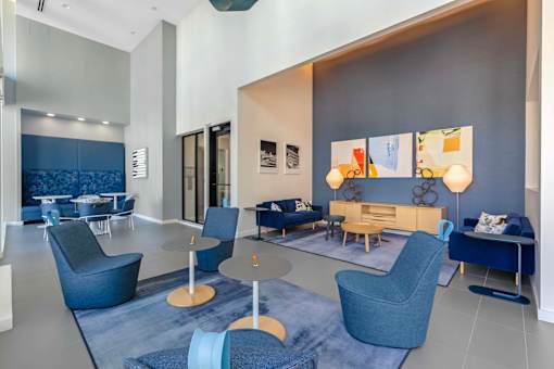 A modern living room with blue chairs and a grey couch.