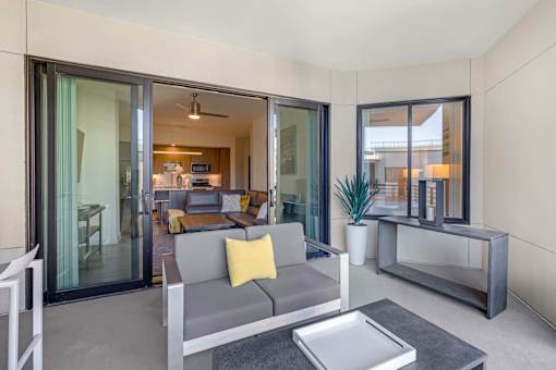 A modern living room with a grey sofa and a coffee table.