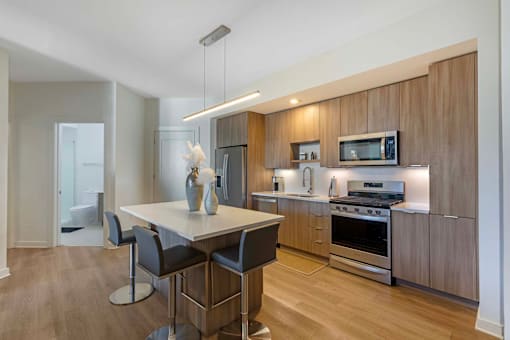A modern kitchen with a dining table and chairs.