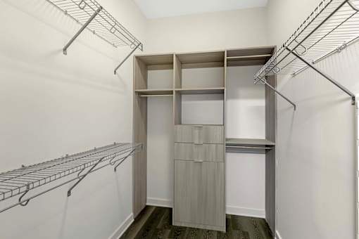 A walk-in closet with shelving and hanging space.