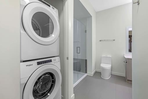 A white Whirlpool washing machine in a laundry room.