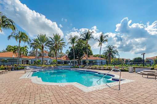 A pool surrounded by palm trees