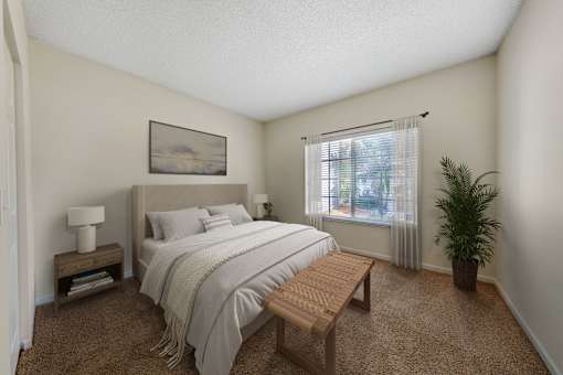 A bedroom with a bed, nightstand, and window.