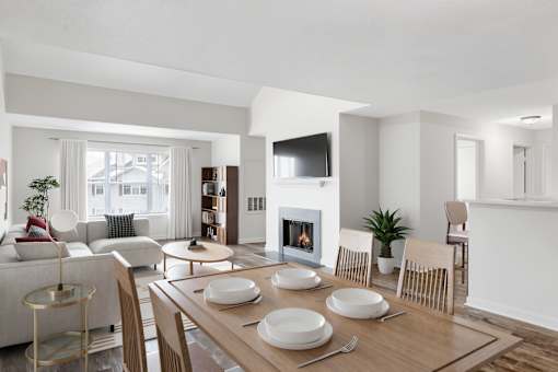 A modern dining room with a fireplace and a TV mounted on the wall at Residences at Westborough Station, Westborough, MA