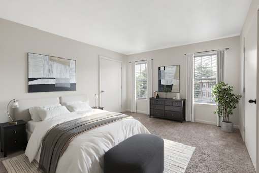 A bedroom with a large bed and a painting on the wall at Residences at Westborough Station, Westborough, MA
