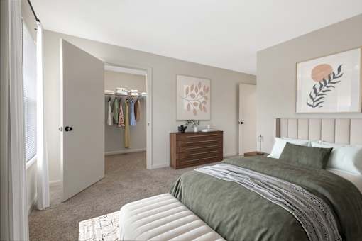 A bedroom with a large bed and a wooden dresser at Residences at Westborough Station, Westborough, MA