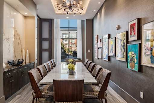 A dining room with a long table and chairs.