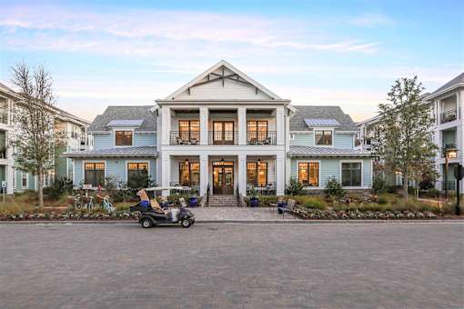 A large house with a driveway in front of it.