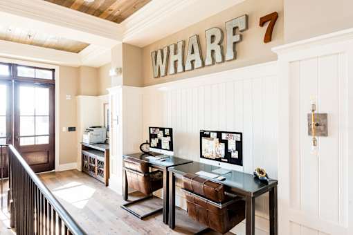 A home office with a desk and computer monitor.