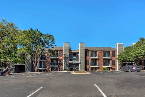 Parking lot in front of a multi-story apartment at Great Hills, Texas, 78759