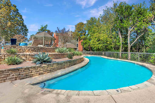 Pool surrounded trees at Great Hills, Austin Texas