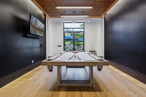 a game room with a ping pong table and a window at The Merc, Waltham, Massachusetts