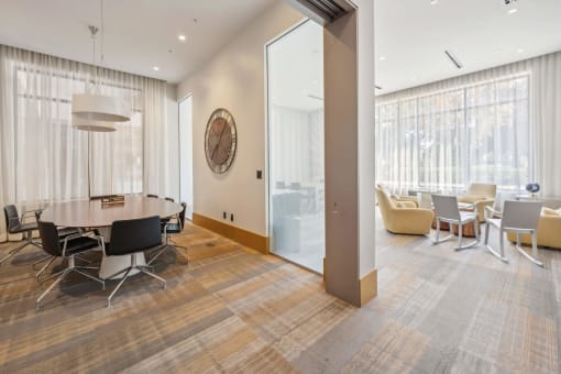 a conference room with a table and chairs and a large window at The Merc, Waltham, 02453