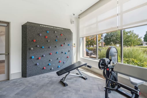 a home gym with a wall graphic of an exercise ball at The Merc, Waltham