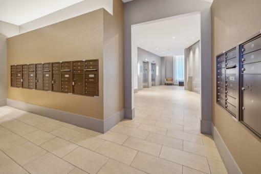 a view of a hallway with mailboxes in a lobby at The Merc, Waltham, MA, 02453