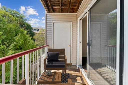 a small balcony with a chair and a door at Residences at Westborough Station, Westborough, MA, 01581