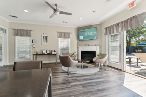 a living room with a fireplace and a table and chairs at Residences at Westborough Station, Westborough, MA