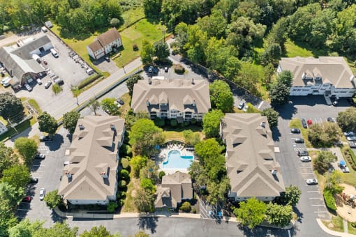 an aerial view of a neighborhood of houses with a swimming pool at Residences at Westborough Station, Westborough, 01581