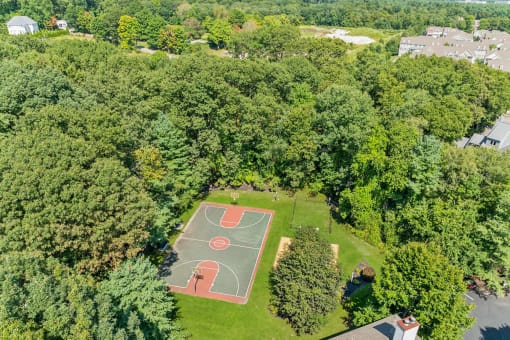 a aerial view of a basketball court in the middle of a park at Residences at Westborough Station, Westborough, Massachusetts