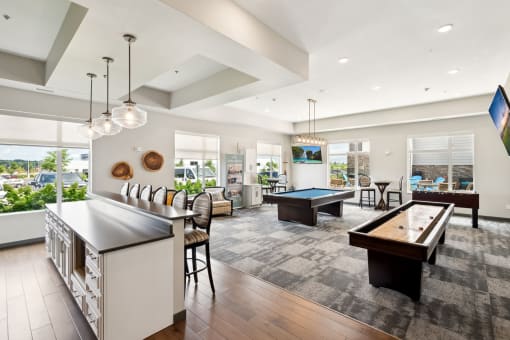 a clubroom with a demonstration kitchen at SoRoc on Maine in Rochester, MN