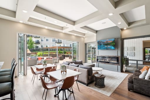 an open layout clubhouse with large doors that open to the outside at SoRoc on Maine in Rochester, MN