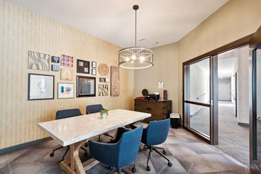 A conference room with a table and chairs.