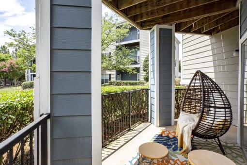 a balcony with two chairs and an egg chair at Thornberry Apartments, Charlotte, NC