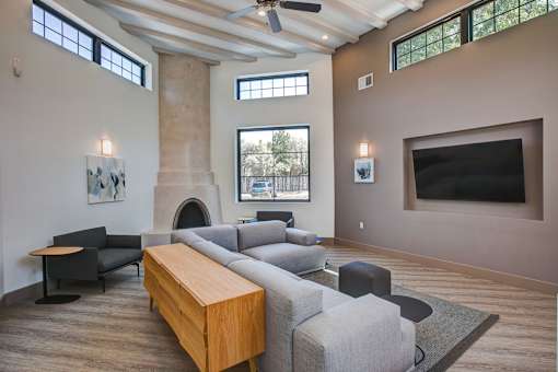 A living room with a grey couch and a wooden table.