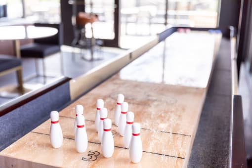 a row of bowling pins on a shuffleboard court