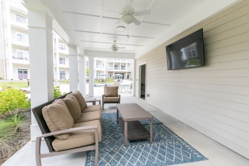Outdoor patio with TVs at The Station at River Crossing, Macon