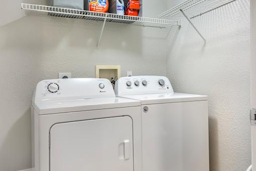A white washing machine and dryer in a small laundry room.